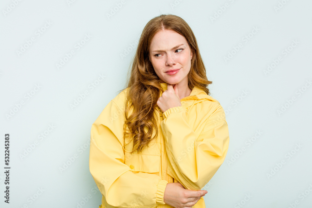 Young caucasian woman isolated on blue background suffers pain in throat due a virus or infection. Young caucasian woman isolated on blue background suffers pain in throat due a virus or infection.