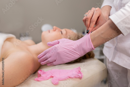 woman wears pink medical gloves. Spa concept relaxation and self-care