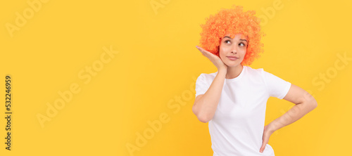 Woman isolated face portrait, banner with copy space. looking so cute. woman has orange hair. being a clown. april fools day. time for fun.