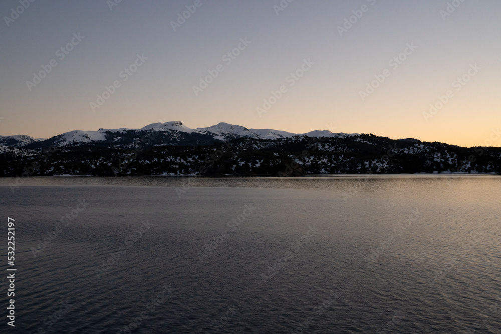 The lake and mountains at nightfall.	