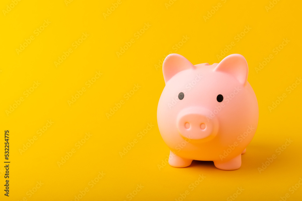Piggy bank on a yellow background.The concept of investment and saving money.Investments.Place of milking text. Place to copy. mockup Piggy bank on a yellow background.The concept of investment and saving money.Investments.Place of milking text. Place to copy. mockup