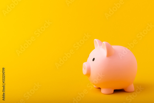 Piggy bank on a yellow background.The concept of investment and saving money.Investments.Place of milking text. Place to copy. mockup