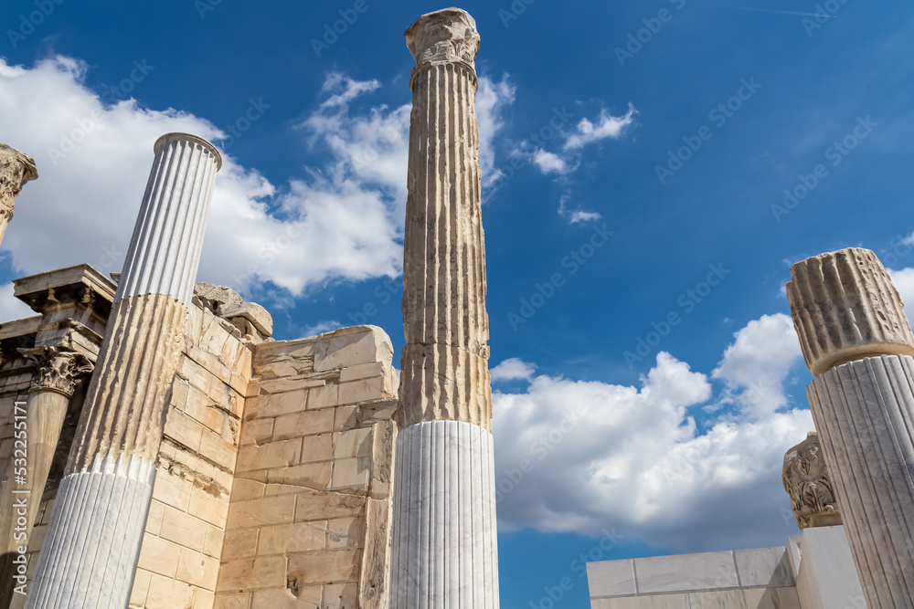 Scenic view of the columns of the ruined Library of Hadrian in Athens, Attica, Greece, Europe. Corinthian columns of the propylon of Pentelic marble. Ruins of ancient agora, birthplace of democracy Scenic view of the columns of the ruined Library of Hadrian in Athens, Attica, Greece, Europe. Corinthian columns of the propylon of Pentelic marble. Ruins of ancient agora, birthplace of democracy