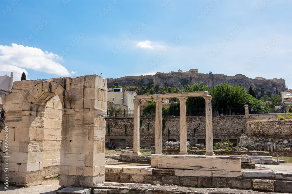 Scenic view of the columns and gate of ruined Library of Hadrian in Athens, Attica, Greece, Europe. Corinthian columns of the propylon of Pentelic marble. Ruins of ancient agora, birthplace democracy Scenic view of the columns and gate of ruined Library of Hadrian in Athens, Attica, Greece, Europe. Corinthian columns of the propylon of Pentelic marble. Ruins of ancient agora, birthplace democracy
