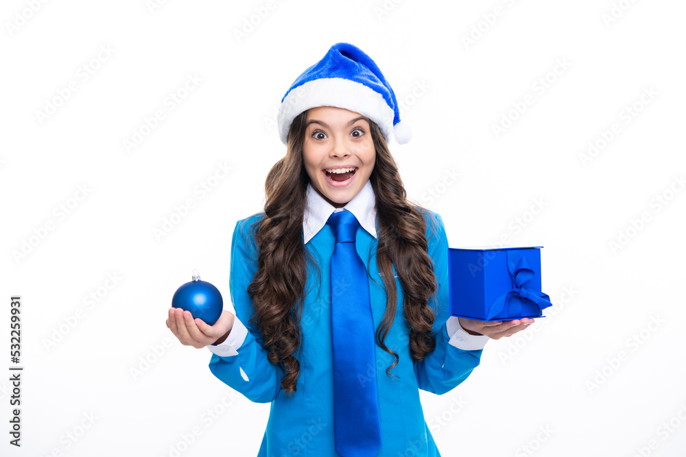 Santa child girl. Excited face. Child in winter wear holding gift for New Year or Christmas. Amazed expression, cheerful and glad. Santa child girl. Excited face. Child in winter wear holding gift for New Year or Christmas. Amazed expression, cheerful and glad.