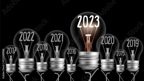 Shining light bulb with New Year 2023 and group of dark light bulbs in a row going from 2016 to 2022 isolated on black background. High quality 4k video.