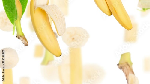 Banana fruit pieces, slices and leaves being moved downwards isolated on white. Seamless looping. High quality 4k video.