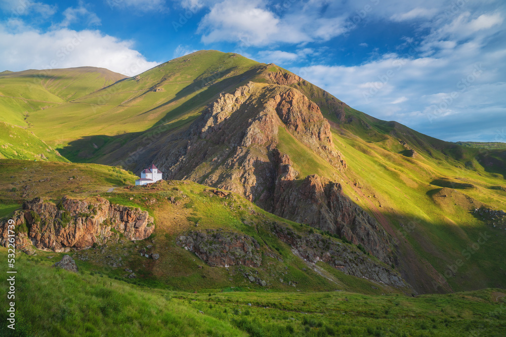 House in mountain green valley and morning sunshine