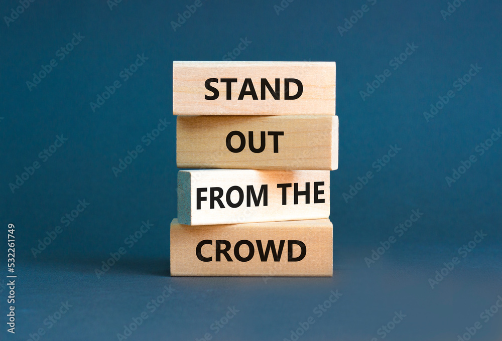 Stand out from the crowd symbol. Concept words Stand out from the crowd on wooden blocks on beautiful grey table grey background. Business, stand out from the crowd concept Stand out from the crowd symbol. Concept words Stand out from the crowd on wooden blocks on beautiful grey table grey background. Business, stand out from the crowd concept