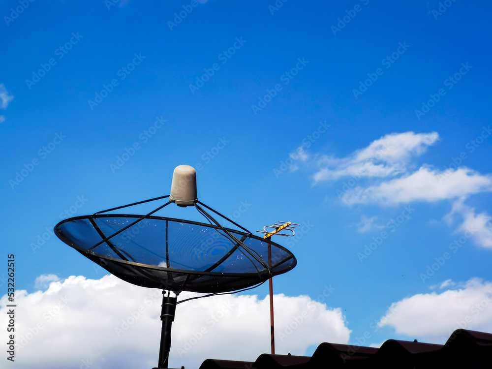 a picture of a cloudy daytime sky and a home tv satellite dish