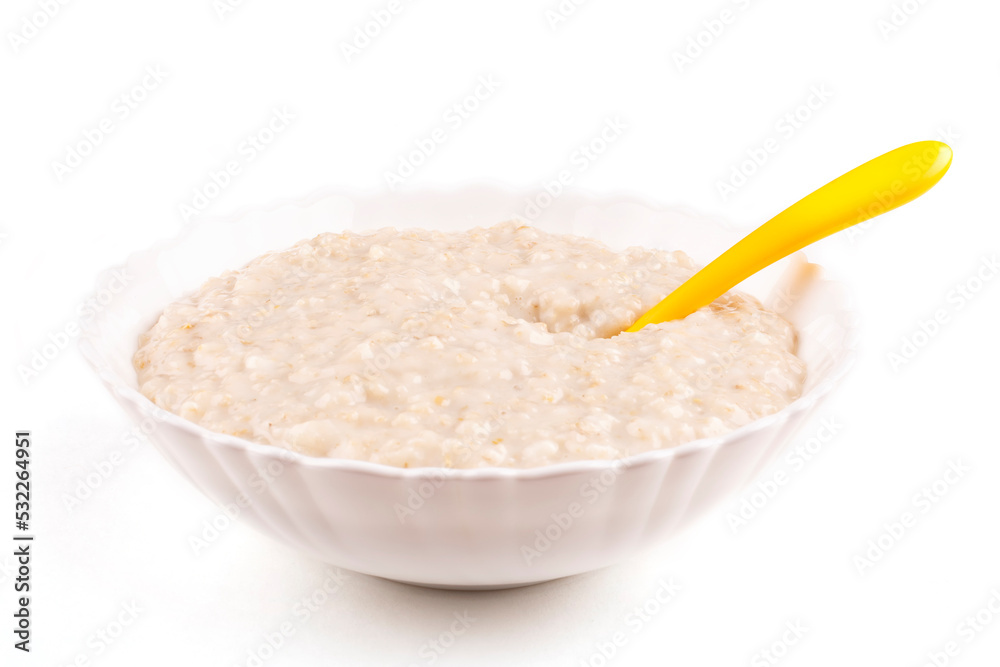 Oatmeal porridge for the baby in a bowl (plate), a yellow spoon on a white isolated background. The first complementary food, baby nutrition. Healthy breakfast. Template, design. Oatmeal porridge for the baby in a bowl (plate), a yellow spoon on a white isolated background. The first complementary food, baby nutrition. Healthy breakfast. Template, design.
