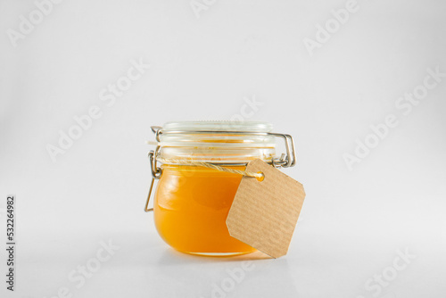 Orange jam in glass jar with label