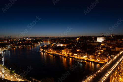 Sunset view of the city of Porto, the sunset is reflected in the river, view of the illuminated city.