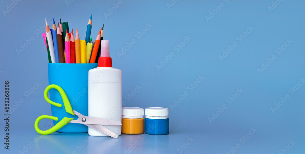 Stationery background - a group of stationery tools on a blue background. Back to school. additional video, banner Stationery background - a group of stationery tools on a blue background. Back to school. additional video, banner