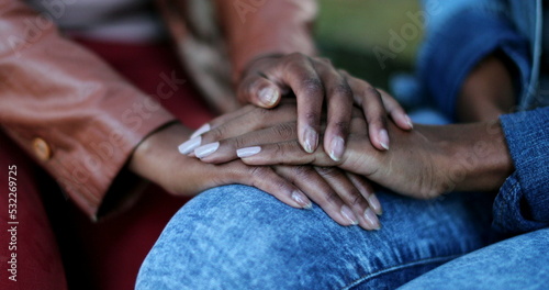 Close-up hands consoling and caring, African black ethnicity