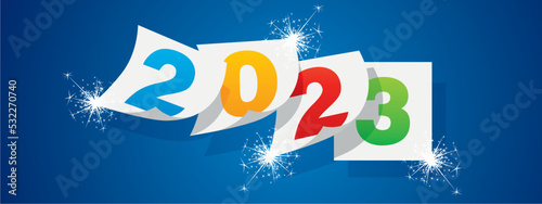Happy New Year 2023 winter holiday colorful greeting card design template with sparkle firework on blue background. New Year 2023 start concept. Calendar pages turn in the wind and the new year begins