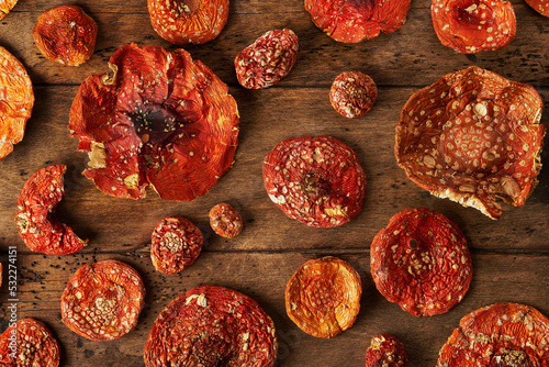 dried fly agarics on a wooden background photo