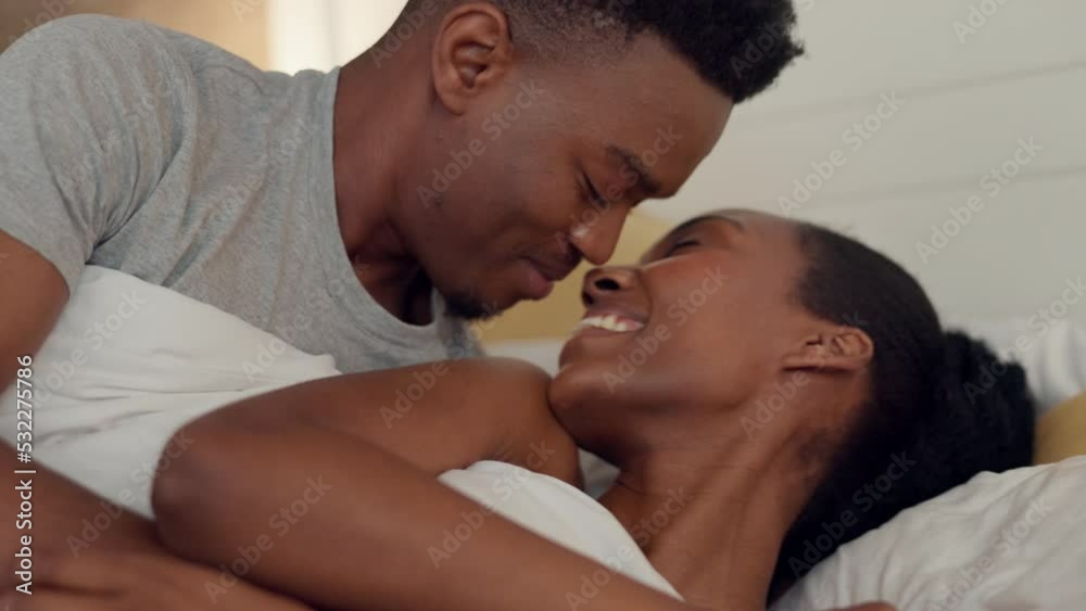 Love, kiss and couple wake up in the morning after relax, peace and calming sleep in hotel bedroom. Happy, smile and black woman and man on a romantic vacation to enjoy quality time and bond together Love, kiss and couple wake up in the morning after relax, peace and calming sleep in hotel bedroom. Happy, smile and black woman and man on a romantic vacation to enjoy quality time and bond together
