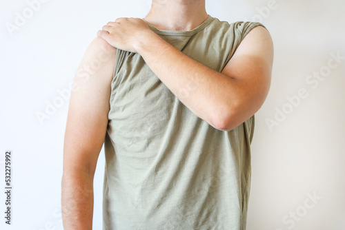 mans tan like t shirt, man show his tan on white background. A very sunburnt man. Looks like a T-shirt with dangerous sunburn to arms and neck