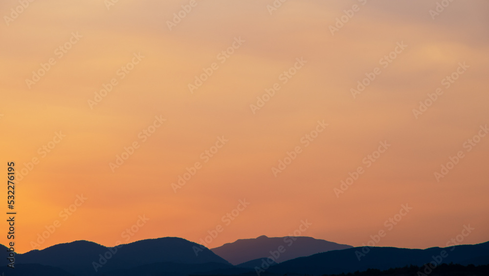 Orange sky over silhouette mountain in the morning.