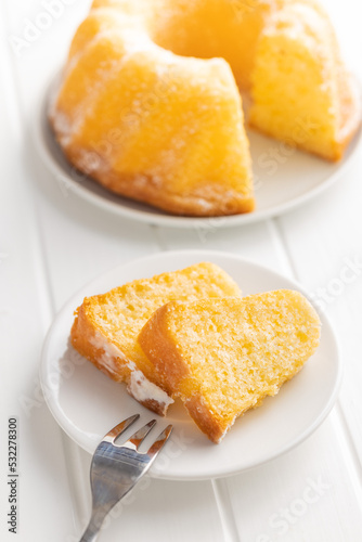 Sweet sponge cake. Bundt cake on plate on white table.