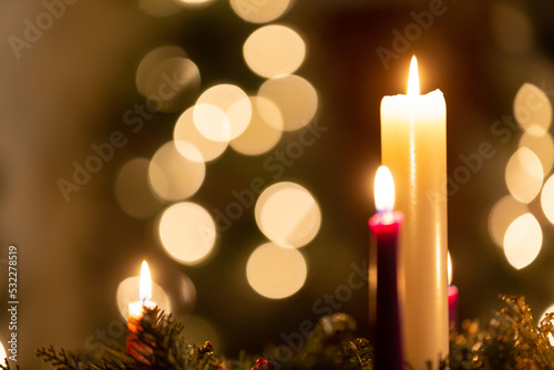 Christmas candles in dark with glowing lights