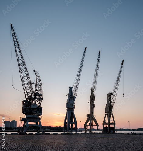 Night sky with old harbor cranes in Antwerp