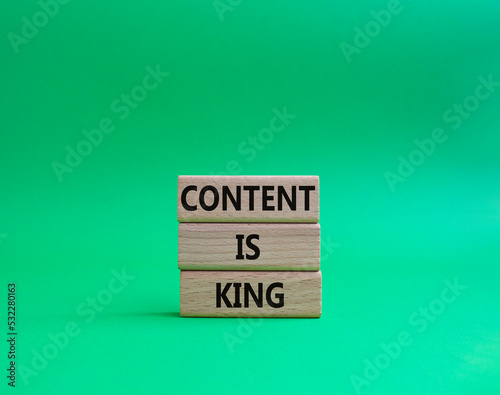 Content is king symbol. Concept words Content is king on wooden blocks. Beautiful green background. Business and Content is king concept. Copy space.