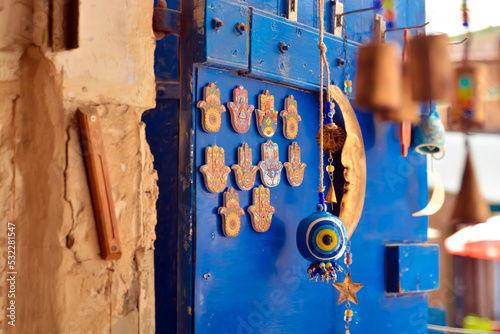 Colorful vintage item hamsa
   of a light blue door in the old city of Safed. In Israel in a spectacular antique store