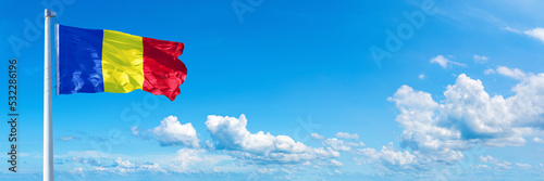 Romania flag on a blue sky *** Horizontal banner 12000 x 4005 px