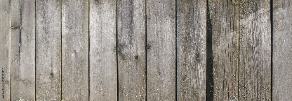Wooden texture with horizontal lines. The texture of wood with knots and holes. The background of a wooden fence damaged by time. Banner of an old wooden fence.