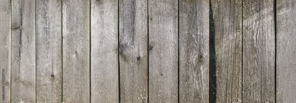 Wooden texture with horizontal lines. The texture of wood with knots and holes. The background of a wooden fence damaged by time. Banner of an old wooden fence. Wooden texture with horizontal lines. The texture of wood with knots and holes. The background of a wooden fence damaged by time. Banner of an old wooden fence.