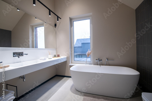 Modern bathroom with clean sanitary ware and LED wall lamps