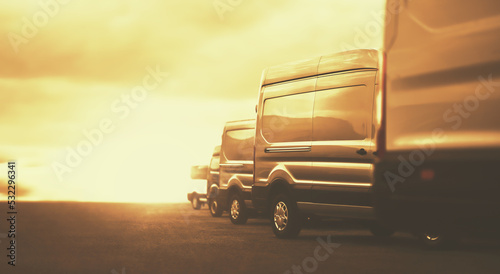 Row of Commercial Vehicles on parking in golden colors