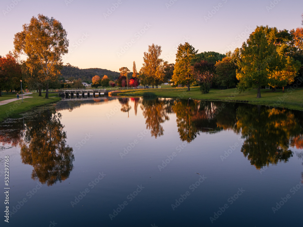 Riverside Evening with Autumnal Trees and Reflections