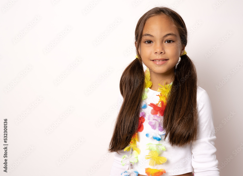 Close up of a little child girl in hawaiian costume standing isolated white background Close up of a little child girl in hawaiian costume standing isolated white background