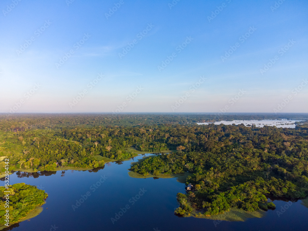 Aerial view of Igapó, the Amazon rainforest in Brazil, an incredible green landscape with lots of water and untouched nature at sunset time