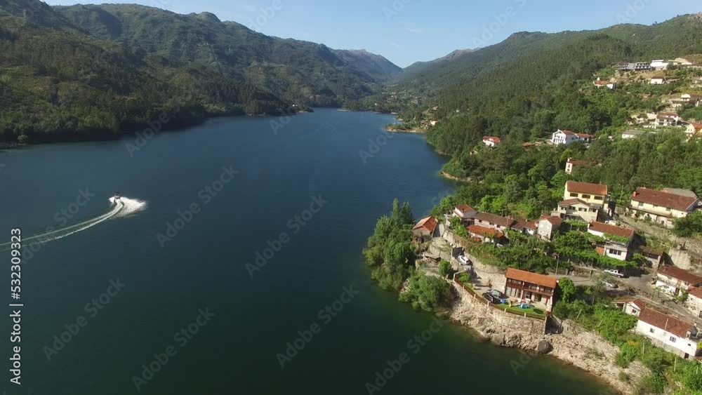 Stunning Nature Landscape from Portugal. National Park of Gerês Aerial View 4k. Travel Destination. Mountain River with Village in the Riverside. River Cavado. Nature Background. Stunning Nature Landscape from Portugal. National Park of Gerês Aerial View 4k. Travel Destination. Mountain River with Village in the Riverside. River Cavado. Nature Background.