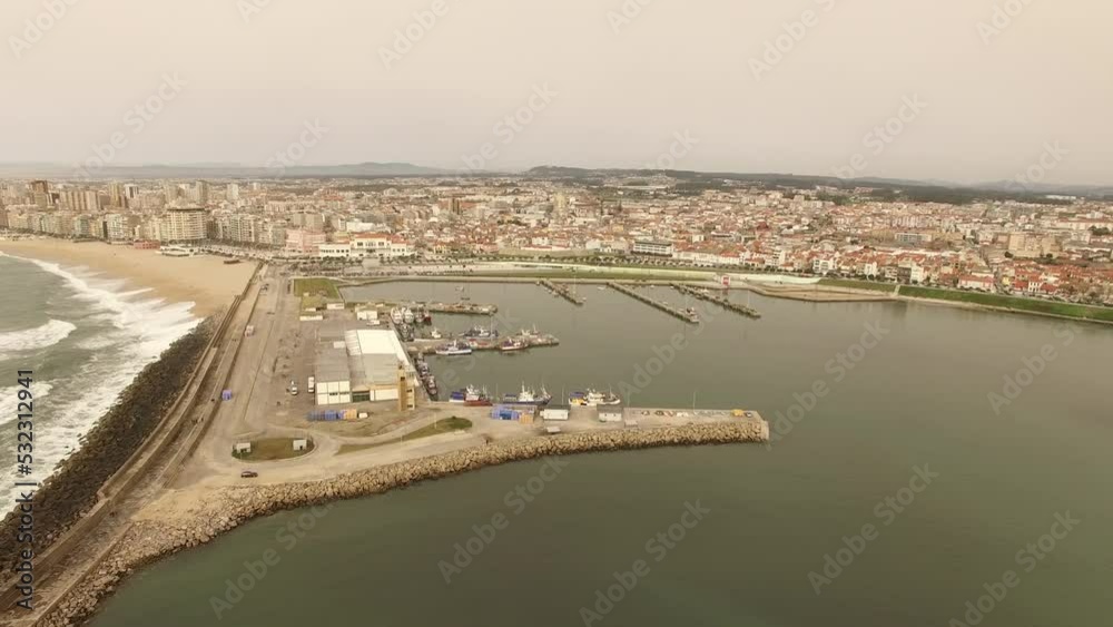 Aerial View City of Póvoa de Varzim Portugal 4k. Beach and City Buildings. Shipyard with boats. City Panorama. Sea Waves Sliding on Sand Beach. Aerial View City of Póvoa de Varzim Portugal 4k. Beach and City Buildings. Shipyard with boats. City Panorama. Sea Waves Sliding on Sand Beach.