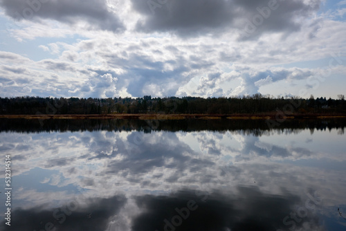Storm Cloud Break Water Reflection. Cloud reflections on Burbaby Lake, British Columbia, Canada.