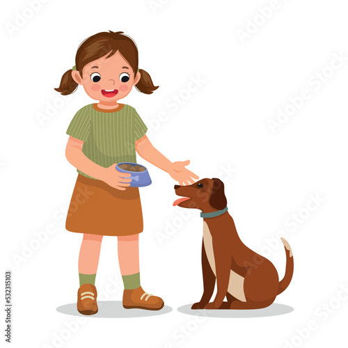 cute little girl feeding her dog pet with animal food