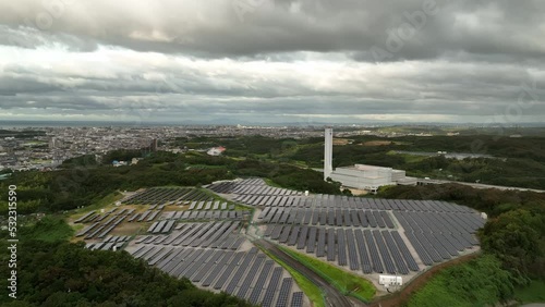 Aerial rotation around panels at small solar farm on cloudy day