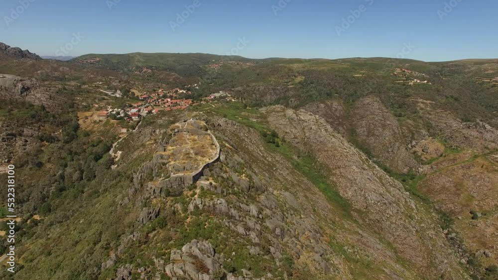 Flying Over Village of Castro Laboreiro. National Park of Gerês. Portugal 4k. Medieval Castle Ruins on the Mountain Top. Travel Destination. Summer Day with Blue sky. Flying Over Village of Castro Laboreiro. National Park of Gerês. Portugal 4k. Medieval Castle Ruins on the Mountain Top. Travel Destination. Summer Day with Blue sky.