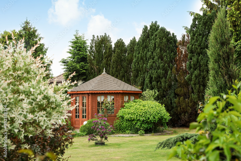 Picturesque view of gazebo in beautiful garden on sunny day
