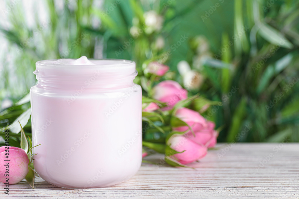 Jar of hand cream and roses on white wooden table, space for text Jar of hand cream and roses on white wooden table, space for text