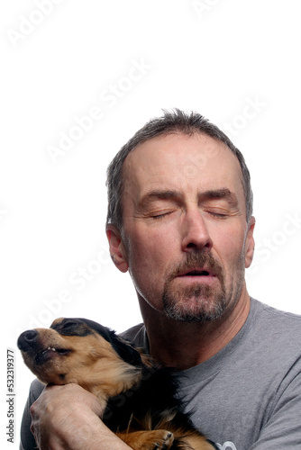 Funny image of a man and his Dachshund looking away from each other on a white background.