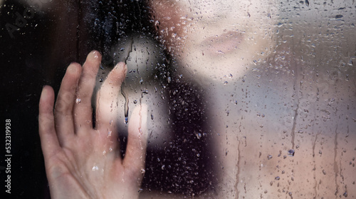 Girl at the wet window