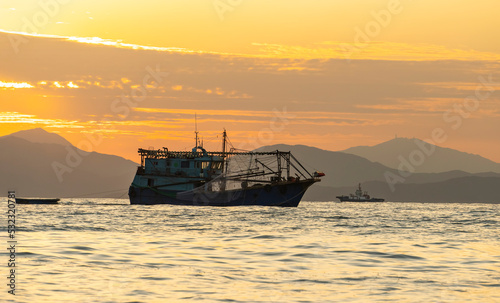 old fishing ship on the sea.scene with a boat in sunset.