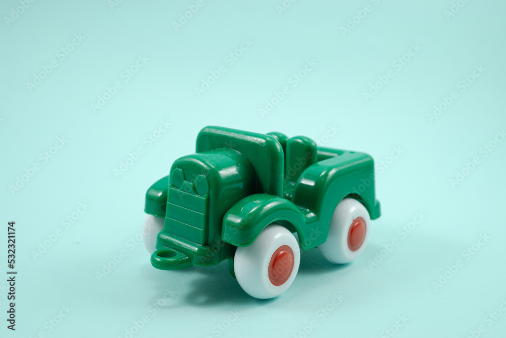 Army car open roof green paint plastic toy isolated on turquoise Army car open roof green paint plastic toy isolated on turquoise