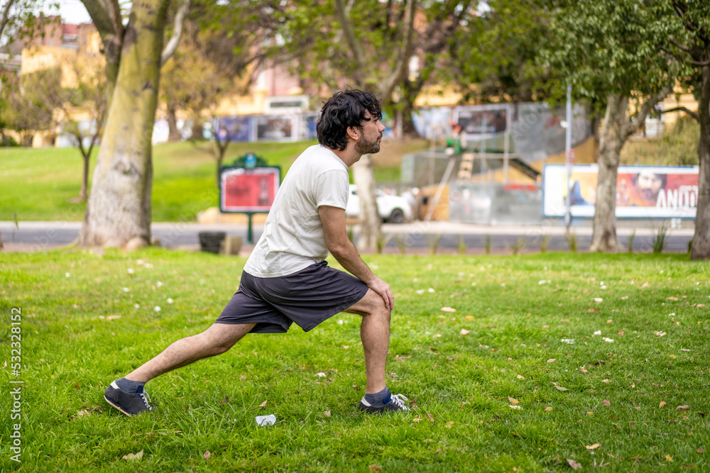Portrait of handsome attractive mature bearded athletic latin man guy 40s doing stretching exercise, preparing for morning workout in the park. Portrait of handsome attractive mature bearded athletic latin man guy 40s doing stretching exercise, preparing for morning workout in the park.